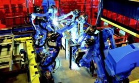 robots arc welding in a manufacturing plant